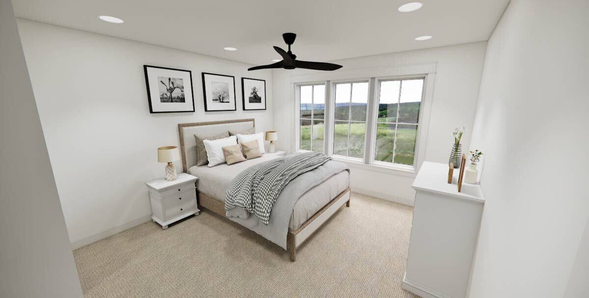 Secondary bedroom with a wooden bed and white cabinets.
