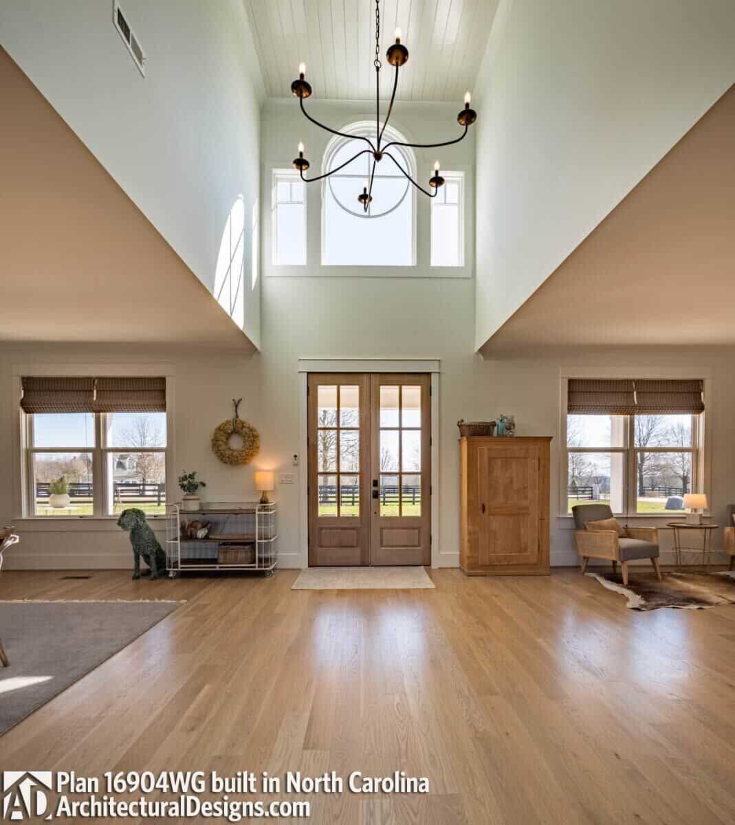 Foyer with a French entry door topped with huge transom windows.
