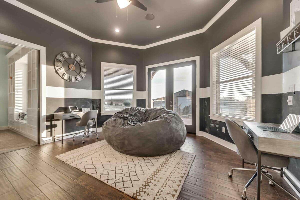 Home office with multiple desks, a bean bag chair, and a French door that opens onto the rear patio.