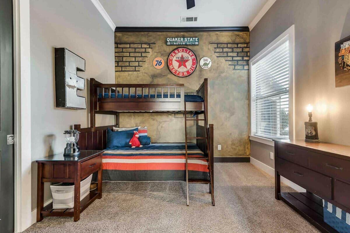 Bedroom with a bunk bed and dark wood cabinets over the carpeted flooring.