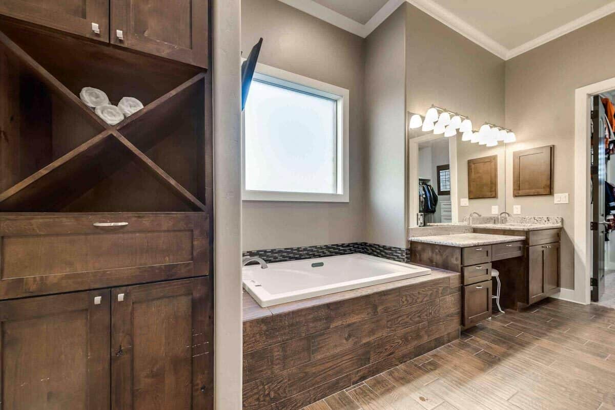 The primary bathroom includes a linen closet, a bathtub, and a large vanity.