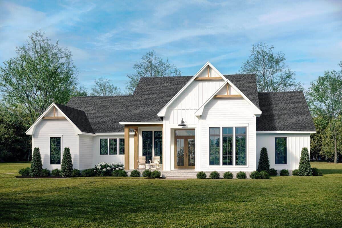 Front view of the house with a covered entry porch and multiple gables accentuated with decorative wood trims.