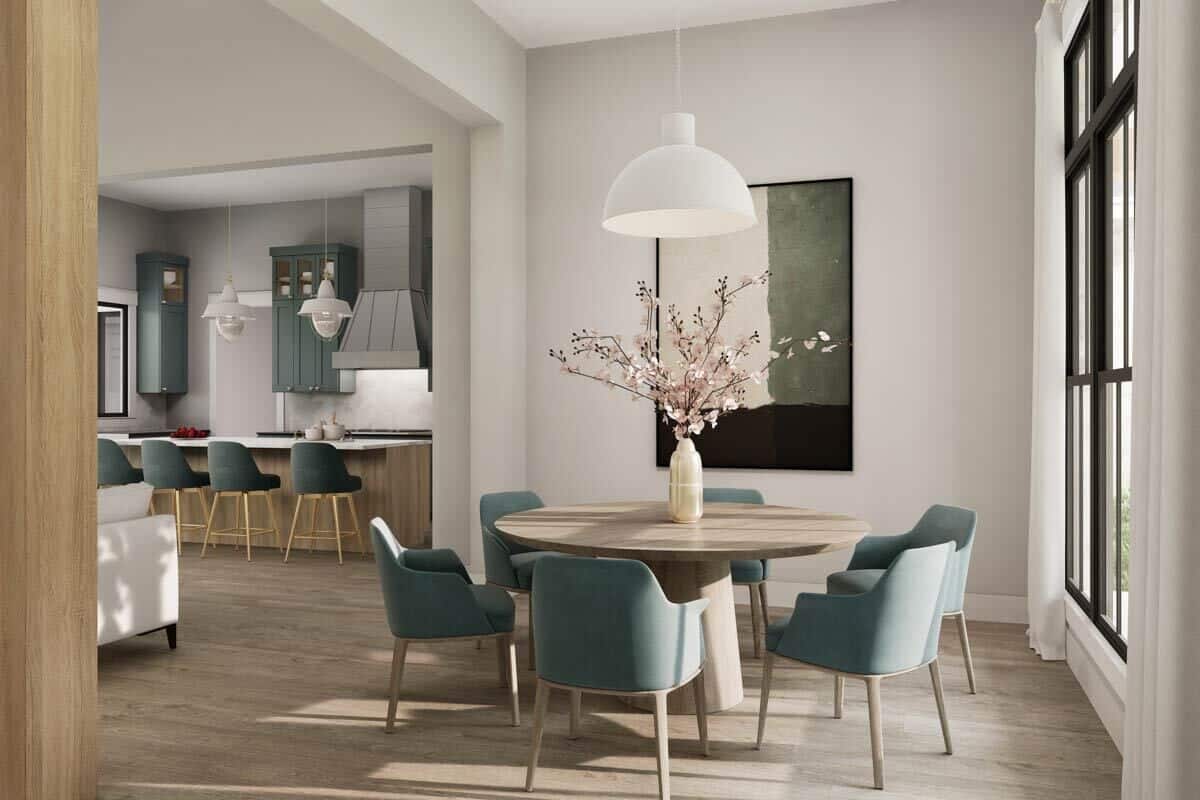 Dining room with a round dining set illuminated by an oversized dome pendant.