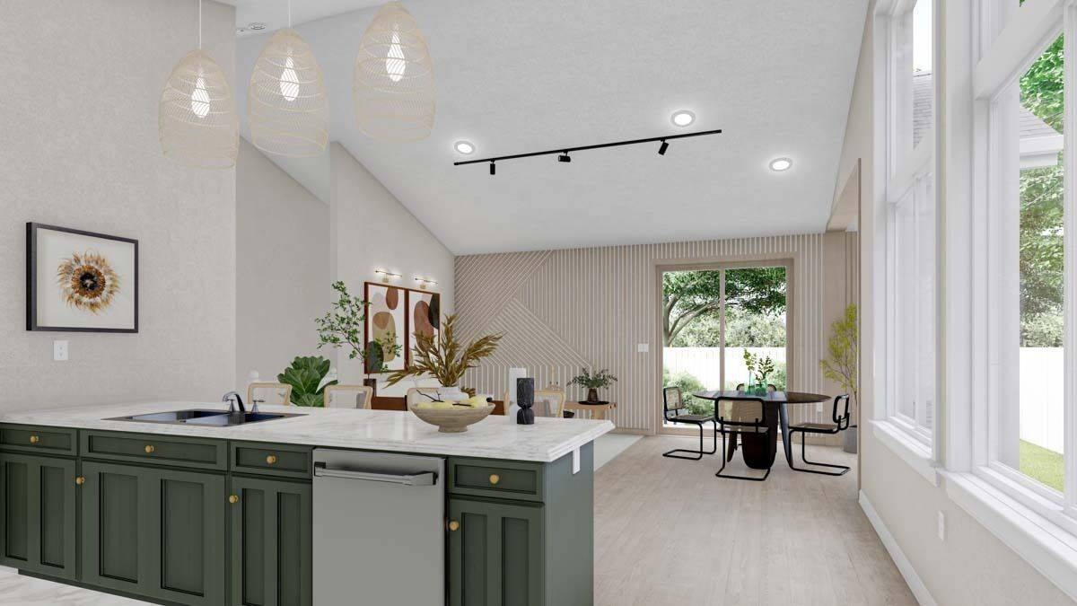 Kitchen island with double sinks and dishwasher overlooking the dining and family rooms.