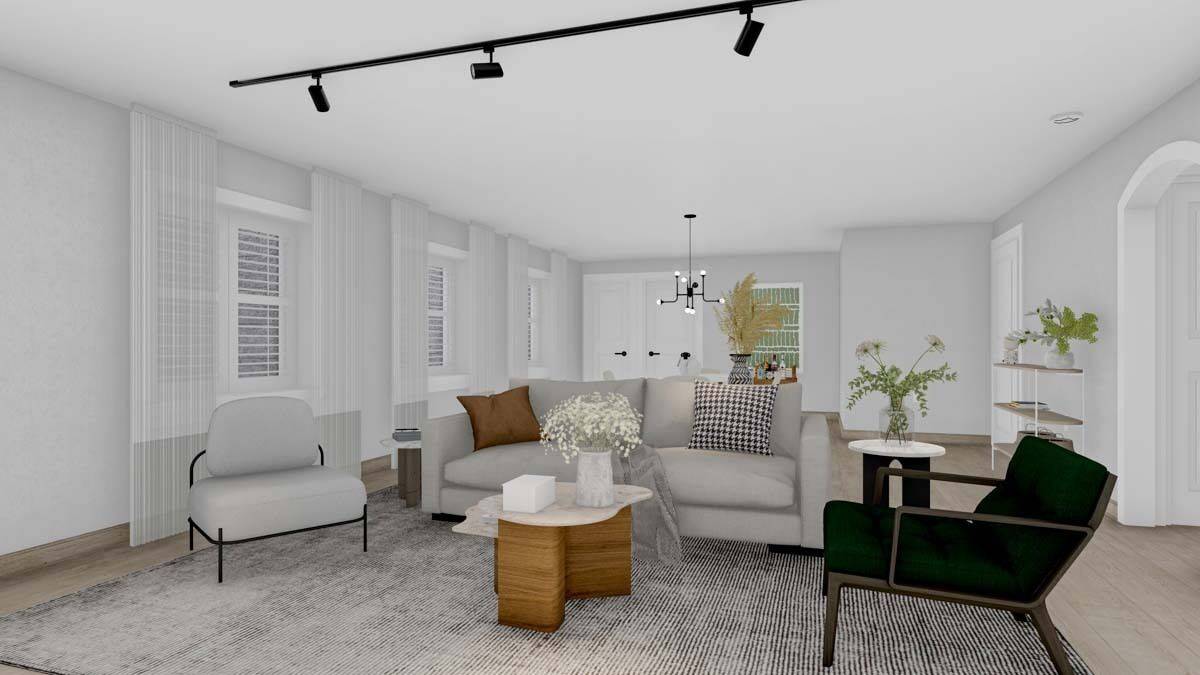Family room with mismatched seats and a wooden coffee table over the distressed area rug.