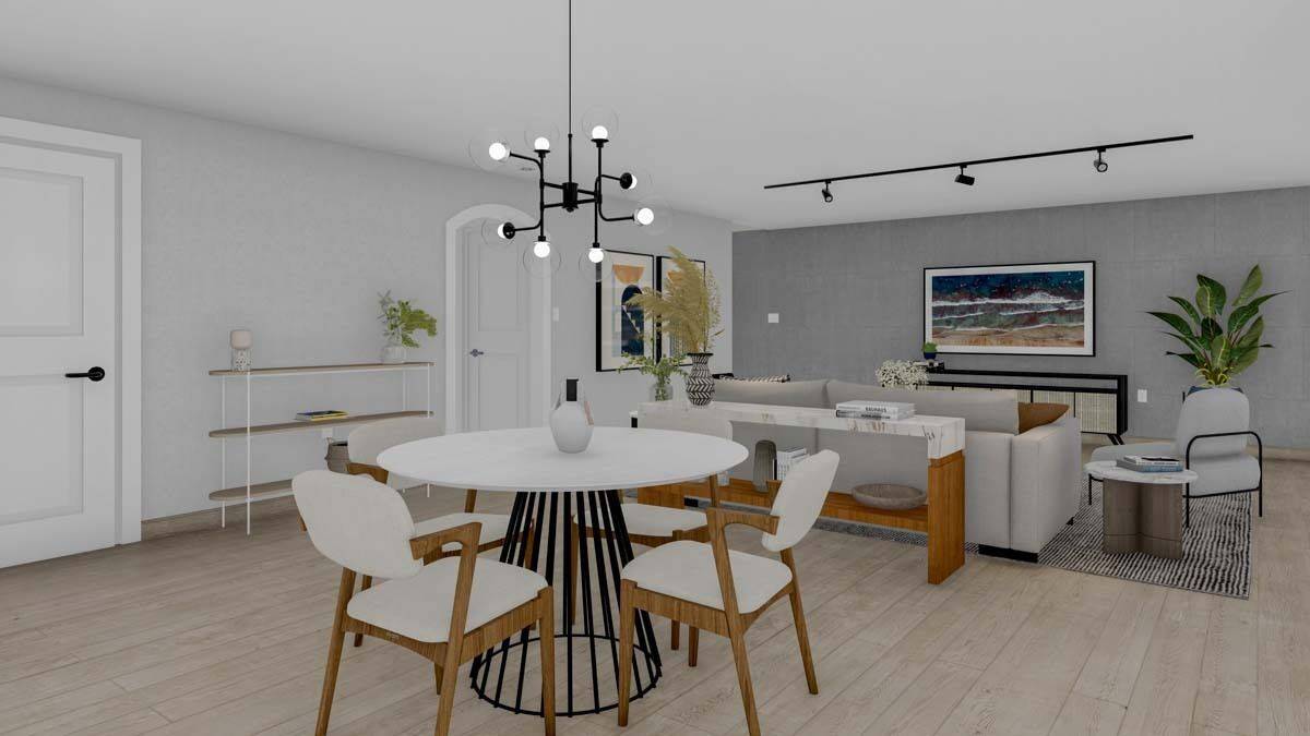 Dining area with cushioned chairs and a round dining table topped with a wrought iron chandelier.
