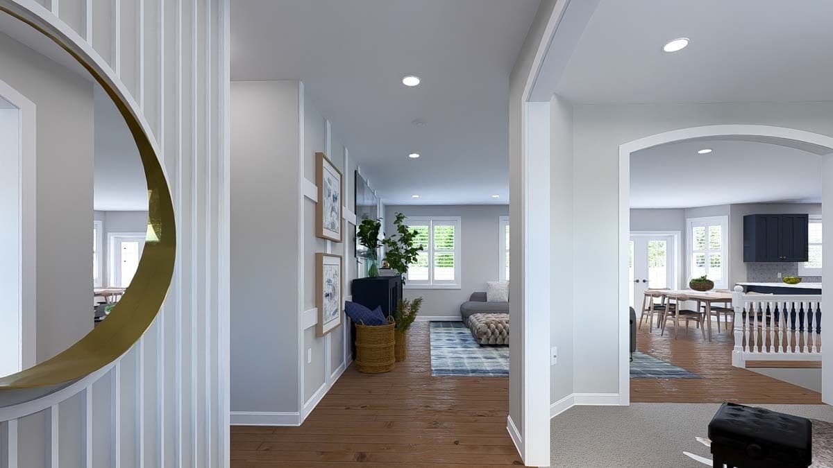 Foyer with a round wall mirror and views of the open-concept living.