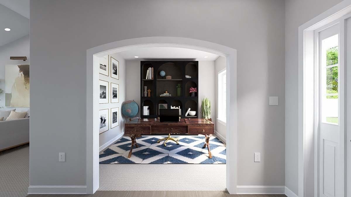 Study with a dark wood bookshelf and a wooden desk over the patterned area rug.
