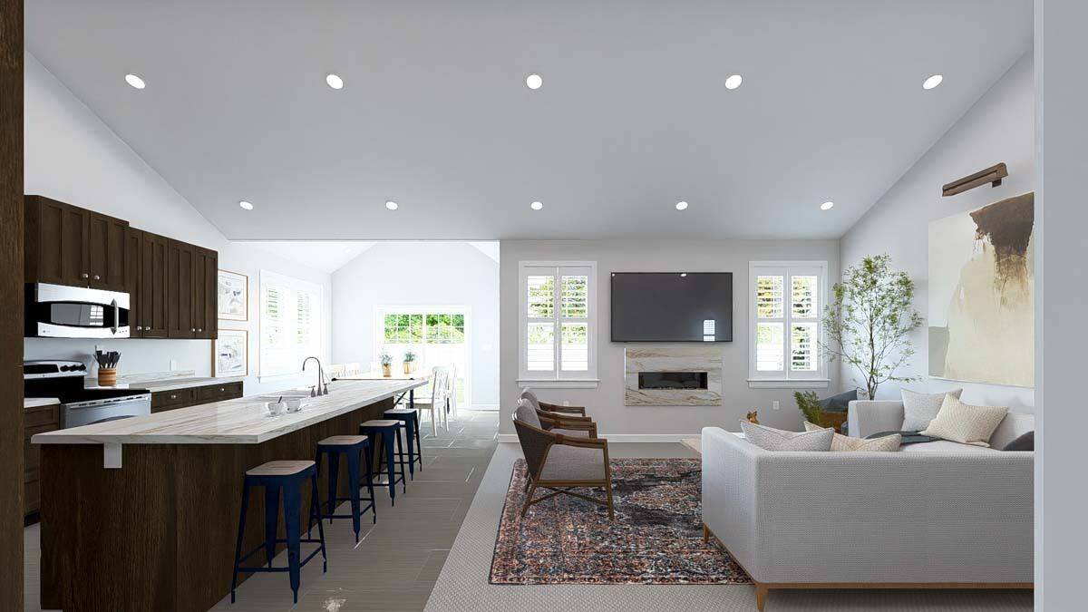 An open layout view of the family room, kitchen, and dining room from the foyer.