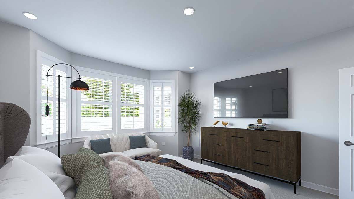 The primary bedroom includes a wall-mounted TV and a dark wood dresser.