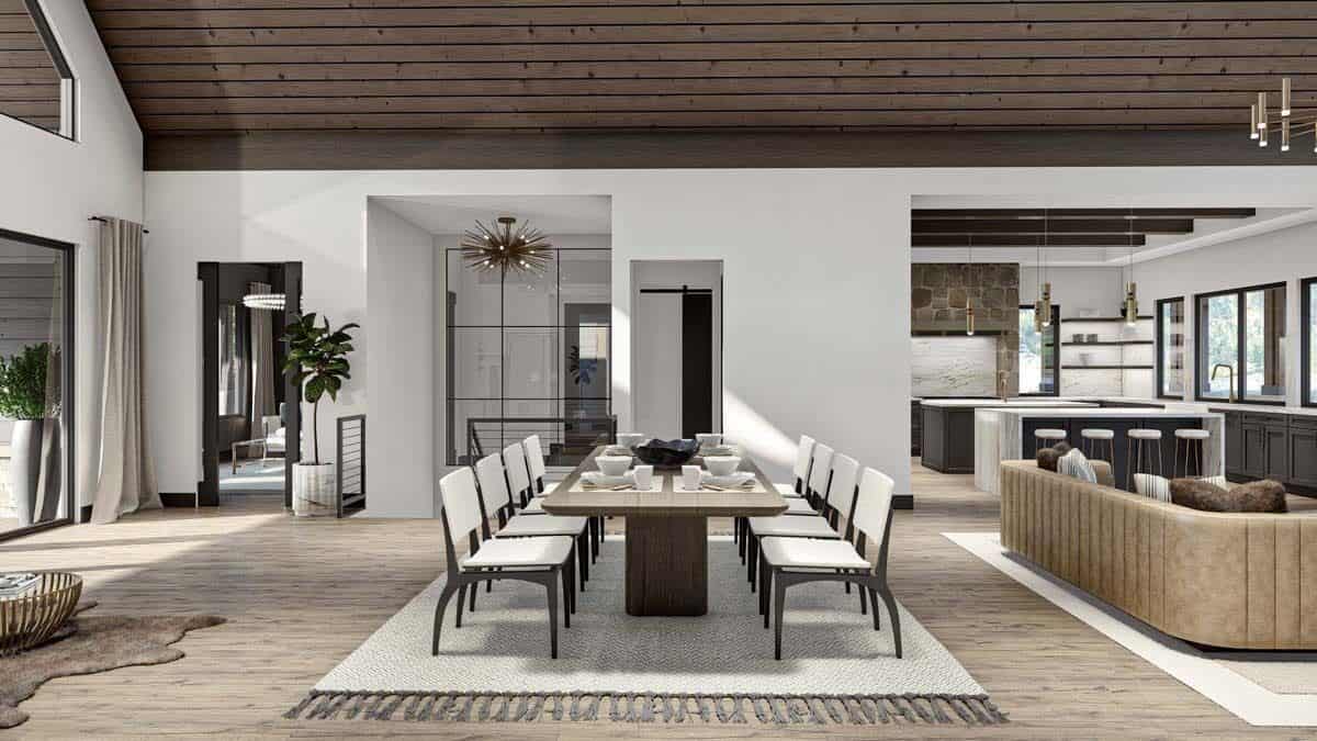 Dining area with a rectangular dining set sitting on a tasseled area rug.