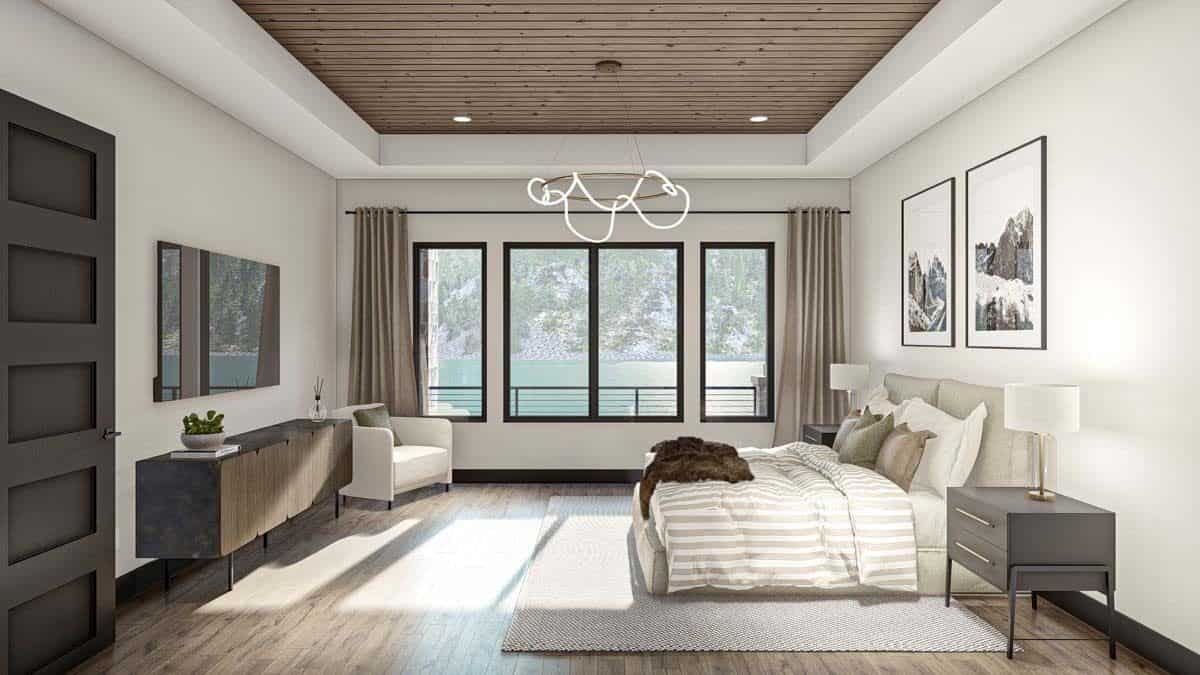The primary bedroom includes a modern armchair and a TV mounted above the console table.
