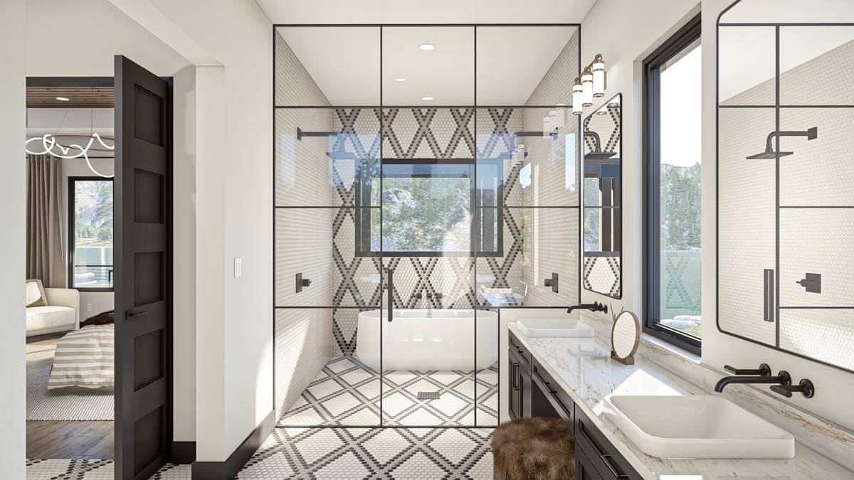 The primary bathroom includes a soaking tub placed under the picture window.