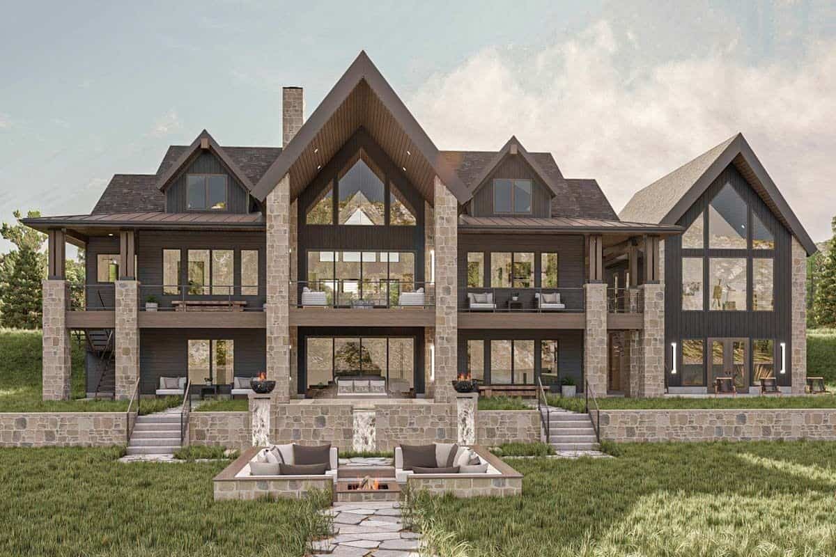 Rear view of the house with stacked porches, a multitude of windows, and a fire pit seating.