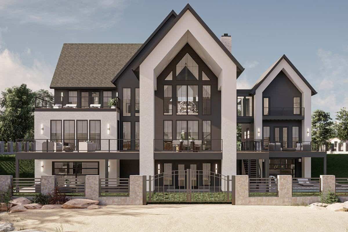 Rear view of the house with sleek gables, expansive decks, and a multitude of windows.