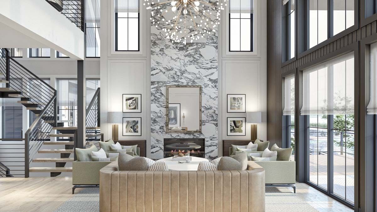 Great room with contemporary seats and a marble fireplace topped with a decorative mirror.