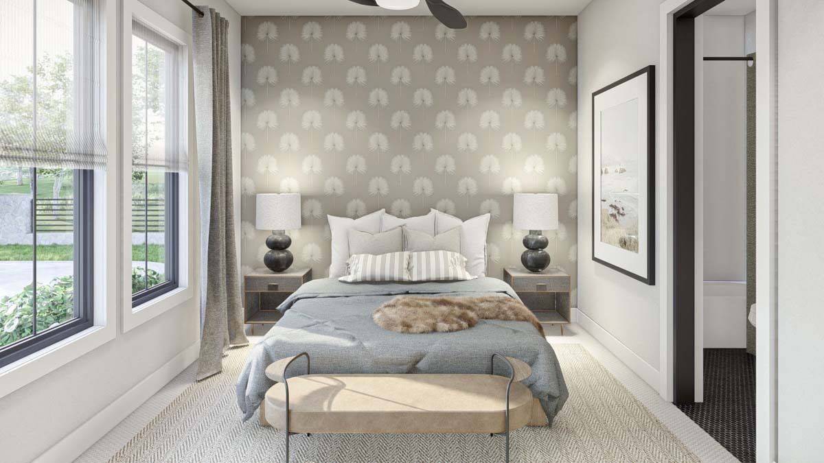 Bedroom with patterned wallpaper, a carpeted floor, and a platform bed complemented with an oval bench.