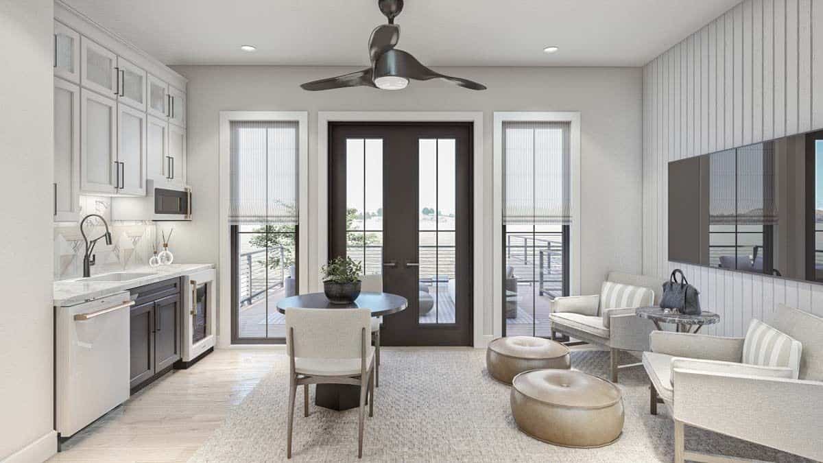 Family room with a wet bar, a wall-mounted TV, and deck access.
