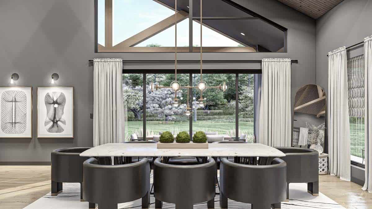 Dining room with round back chairs and a rectangular table topped with a brass chandelier.