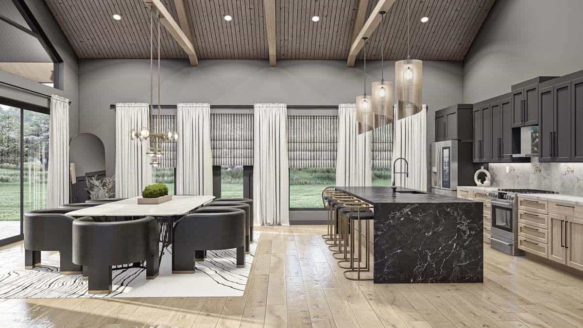 Kitchen and dining room under a vaulted ceiling with exposed trusses.