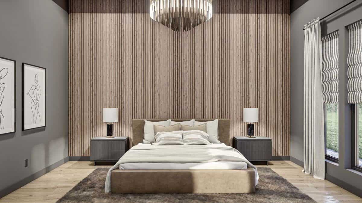 Primary bedroom with gray walls and an upholstered bed against the fluted accent wall.