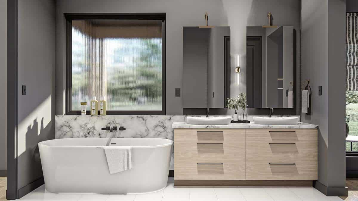 Primary bathroom with a sink vanity and a freestanding tub illuminated by a picture window.