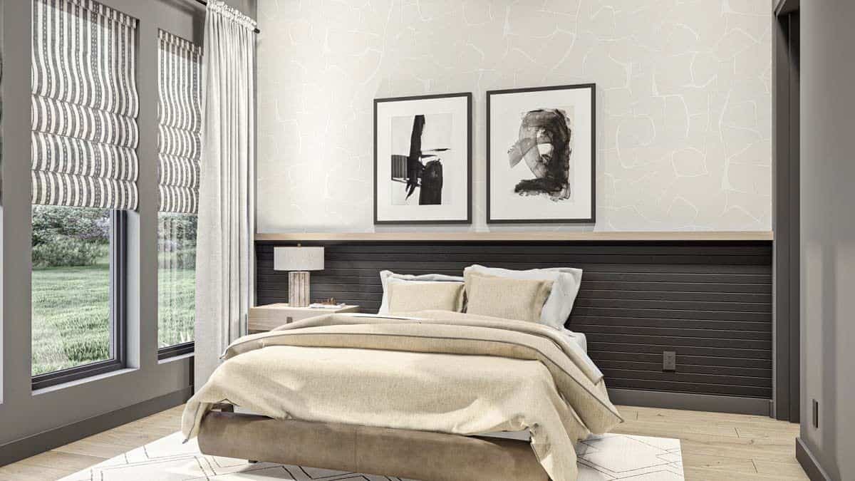 Secondary bedroom with a platform bed and tall windows overlooking the lush yard.