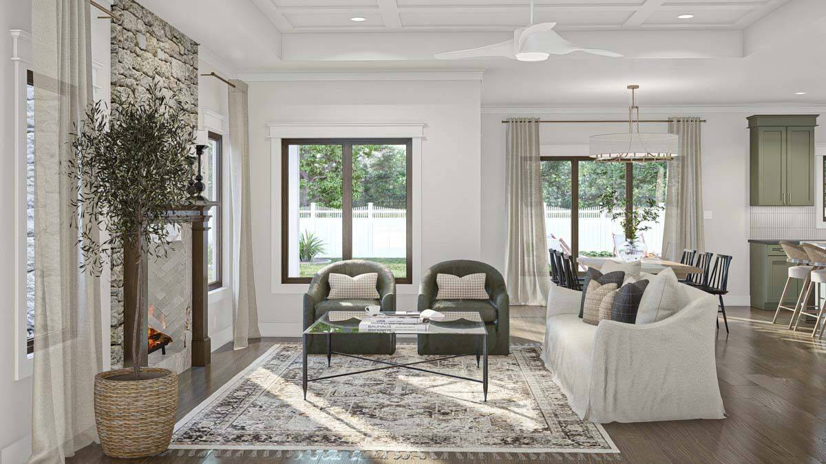Great room with skirted sofa, round back chairs, and a glass-top coffee table over the vintage area rug.