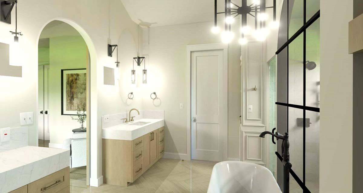 Primary bathroom with his and her vanities and a freestanding tub against the walk-in shower.