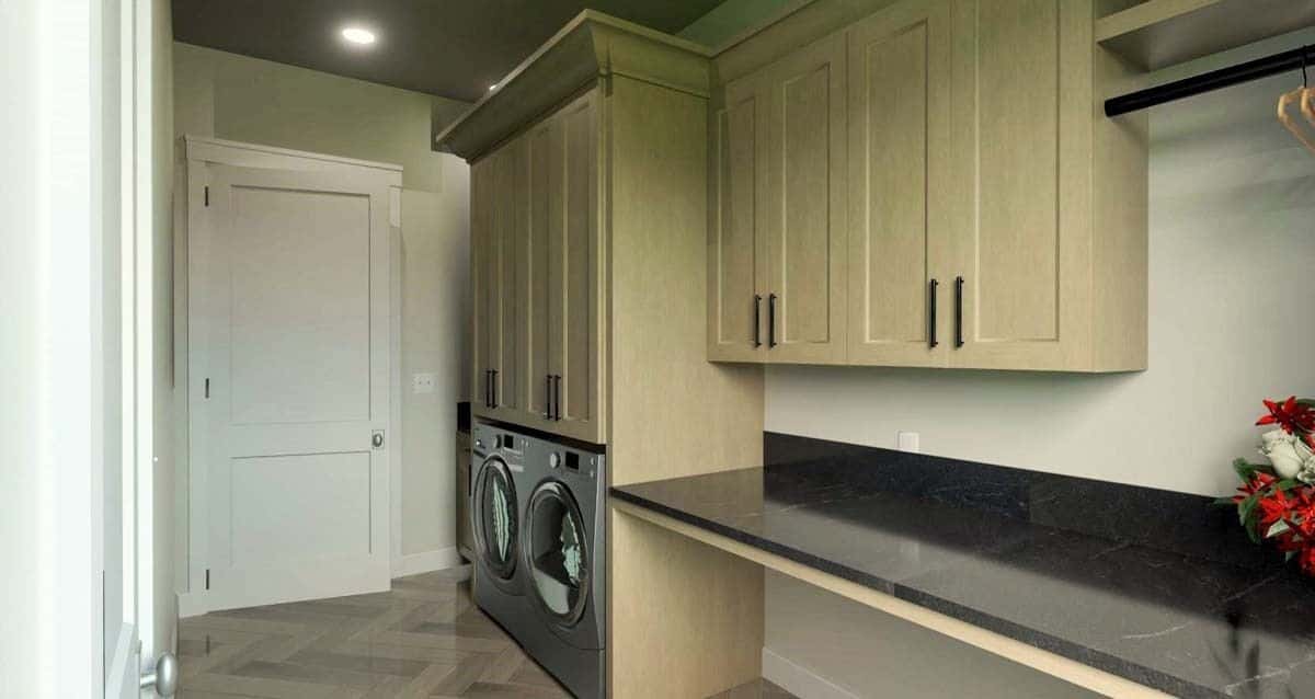 Laundry room with ample storage., a granite countertop, and front-load appliances.