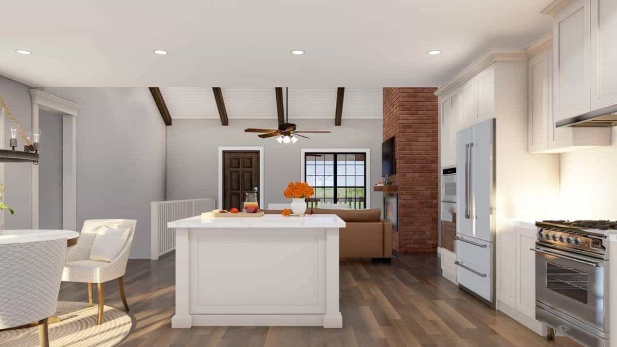 An open layout view of the kitchen, dining area, and vaulted great room,