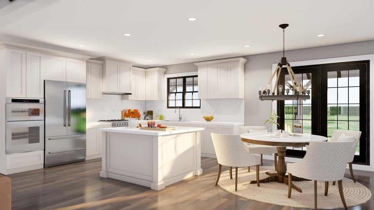 Kitchen and dining area with white cabinetry and a round dining set.