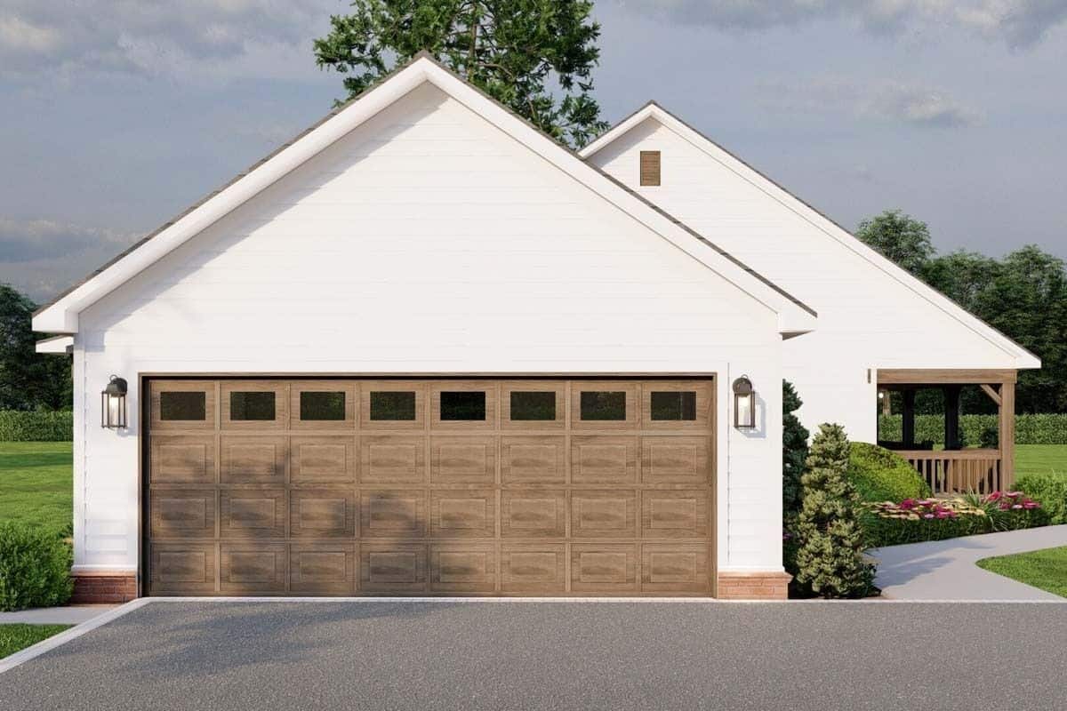 Right view of the house showcasing the double garage with huge wooden doors.