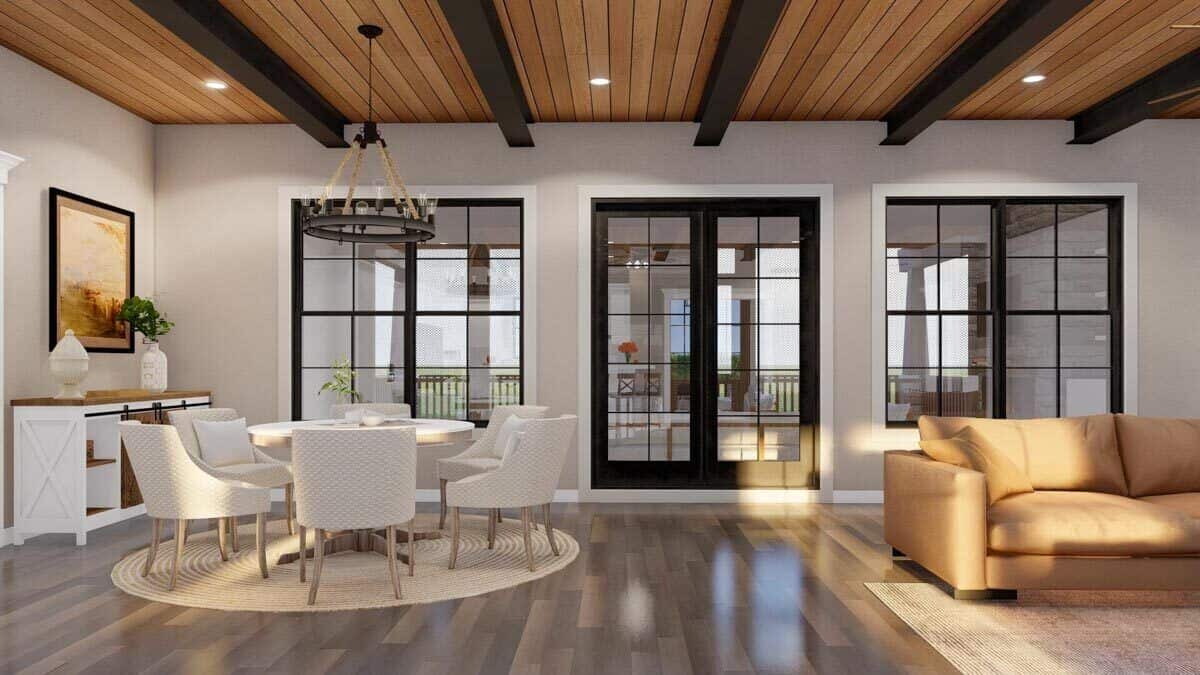 Dining area and great room with hardwood flooring and sliding glass doors that open onto a covered patio.