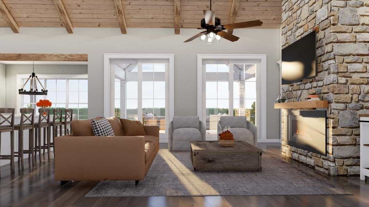 Great room illuminated by sliding glass doors that open to a covered patio.