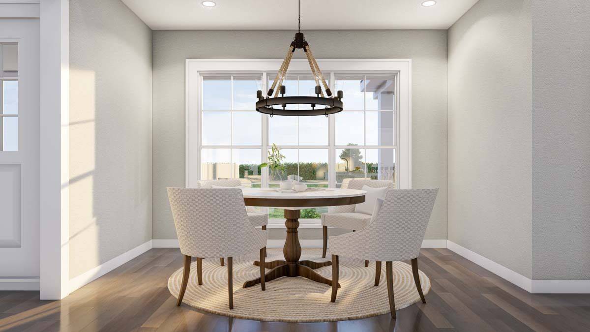 Dining room with upholstered chairs and a wooden dining table over the round area rug.