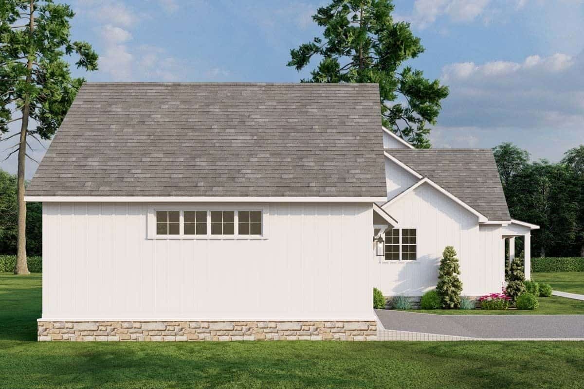 Left view with board and batten siding and a stone base.
