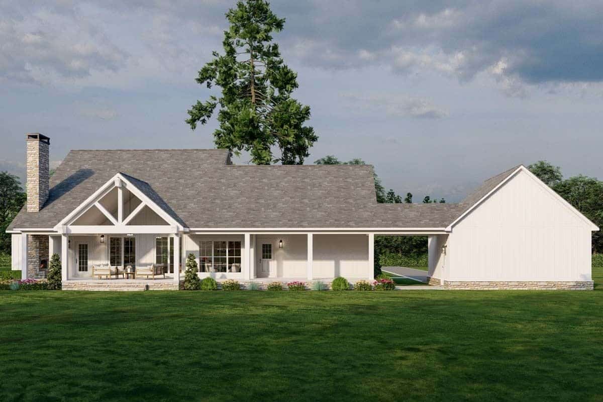 Rear view of the house showcasing a spacious porch warmed by an outdoor fireplace.