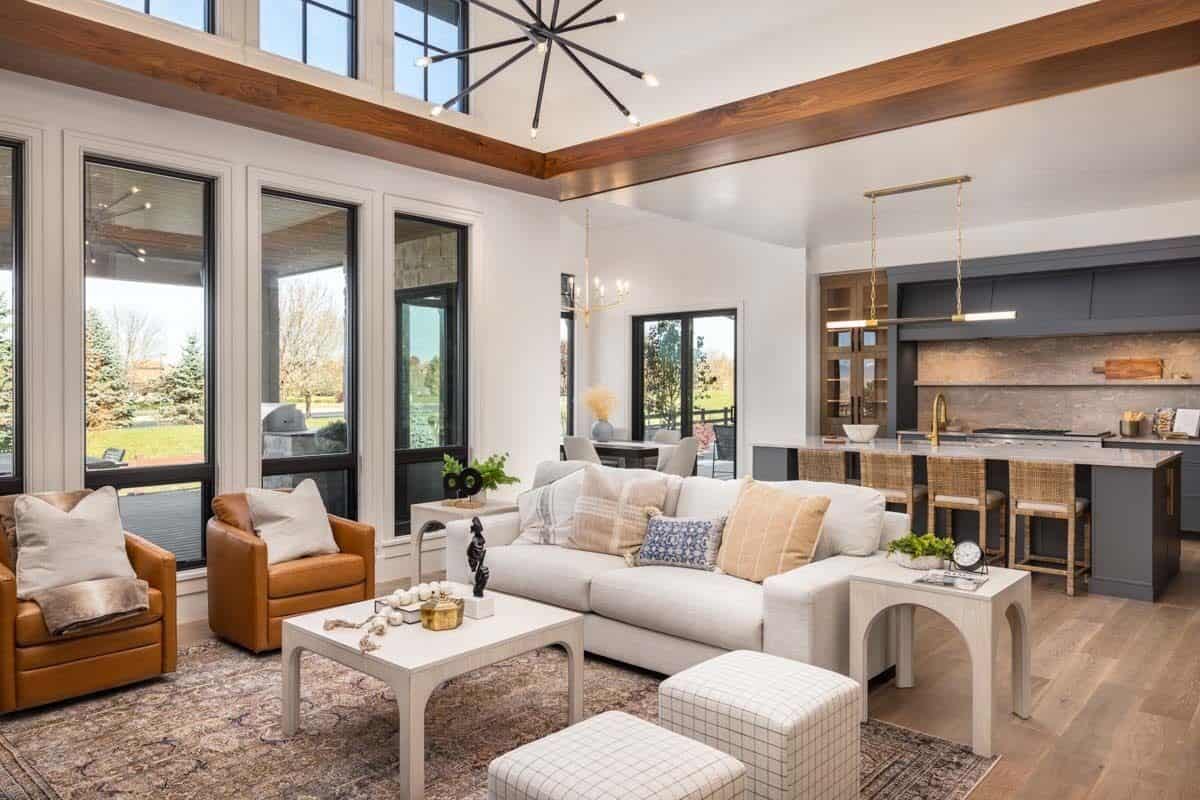 Great room with a tall ceiling, clerestory windows, and mismatched chairs.