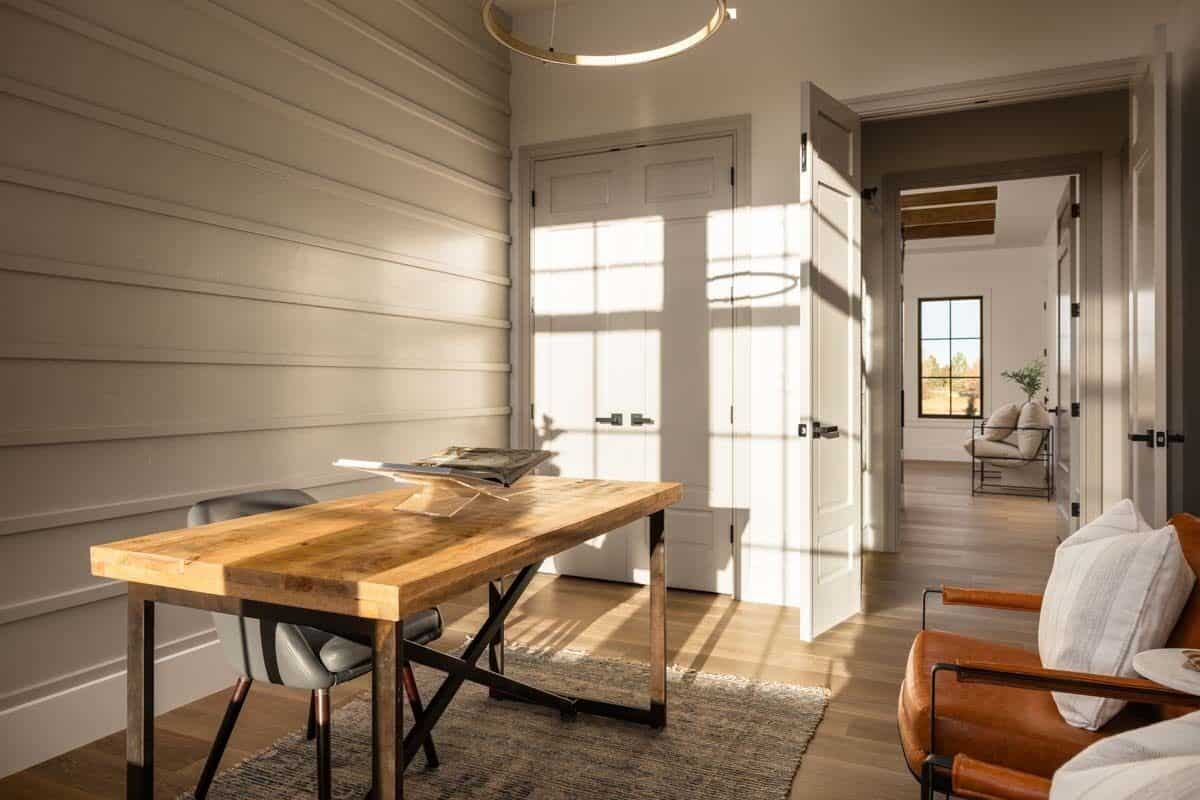 Study with leather chairs and a rustic wooden desk.