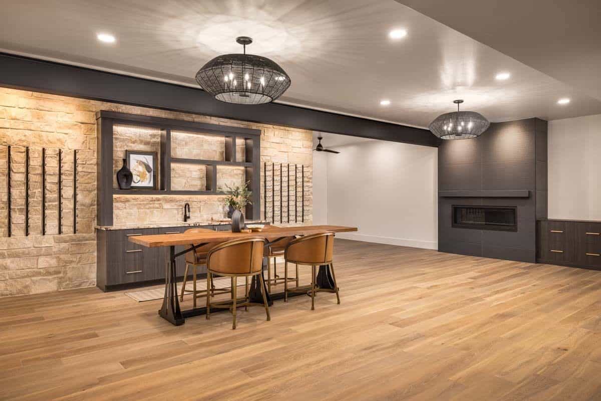 Rec room with a fireplace, a wet bar, and a wooden dining table.