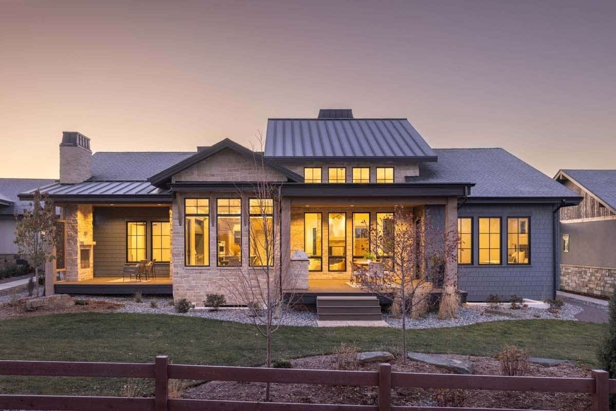 Rear view of the house showcasing the covered patios framed with stone pillars.