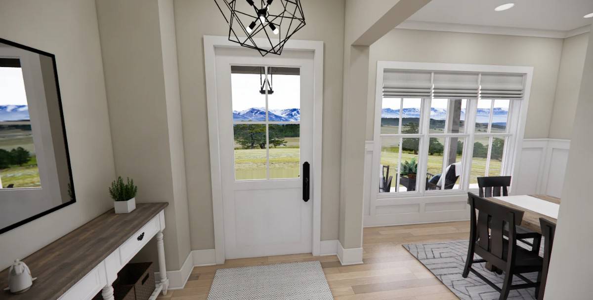 Foyer with a glazed front door and a wooden console table topped with a framed mirror.