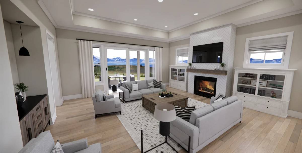Great room with sectional sofas, a fireplace with a TV on top, and a tray ceiling.