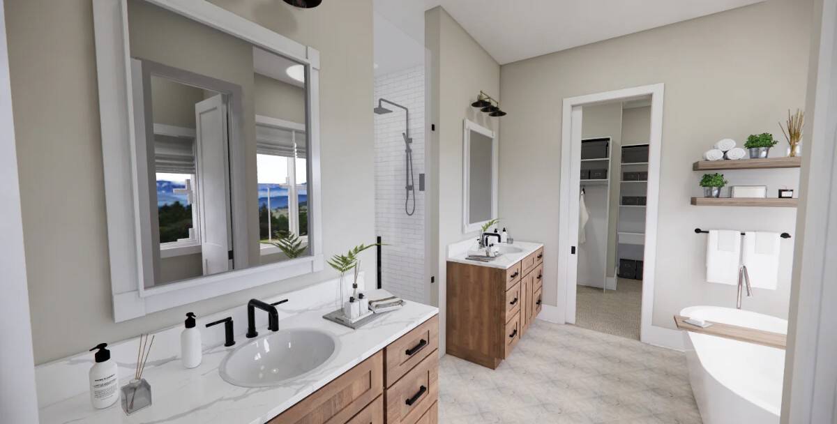 Primary bathroom with his and her vanities, a soaking tub, and a walk-in closet.