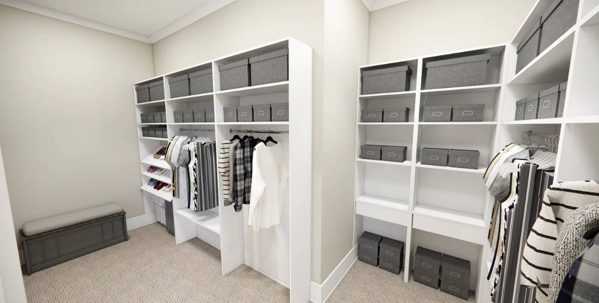 Primary walk-in closet with ample storage and a carpeted floor.