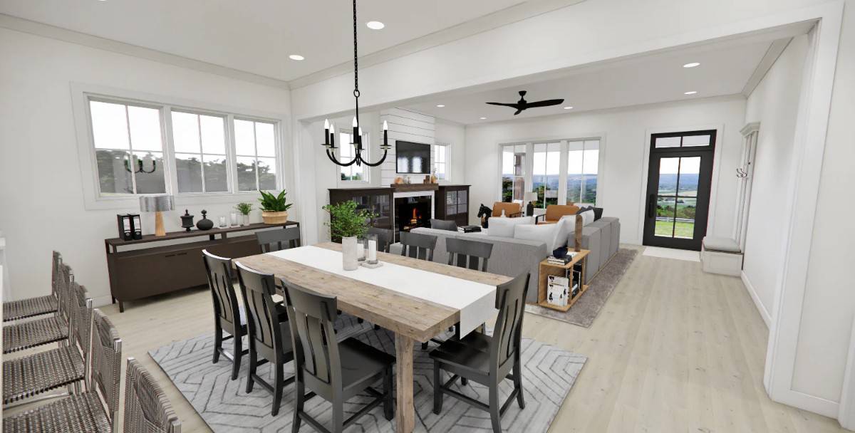 Dining area with a rustic table and black chairs over the patterned area rug.