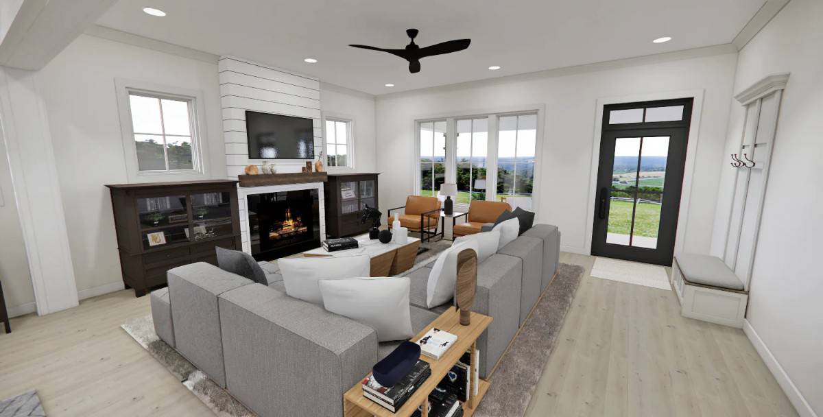 Great room with an L-shaped sectional and a fireplace flanked by dark wood cabinets.