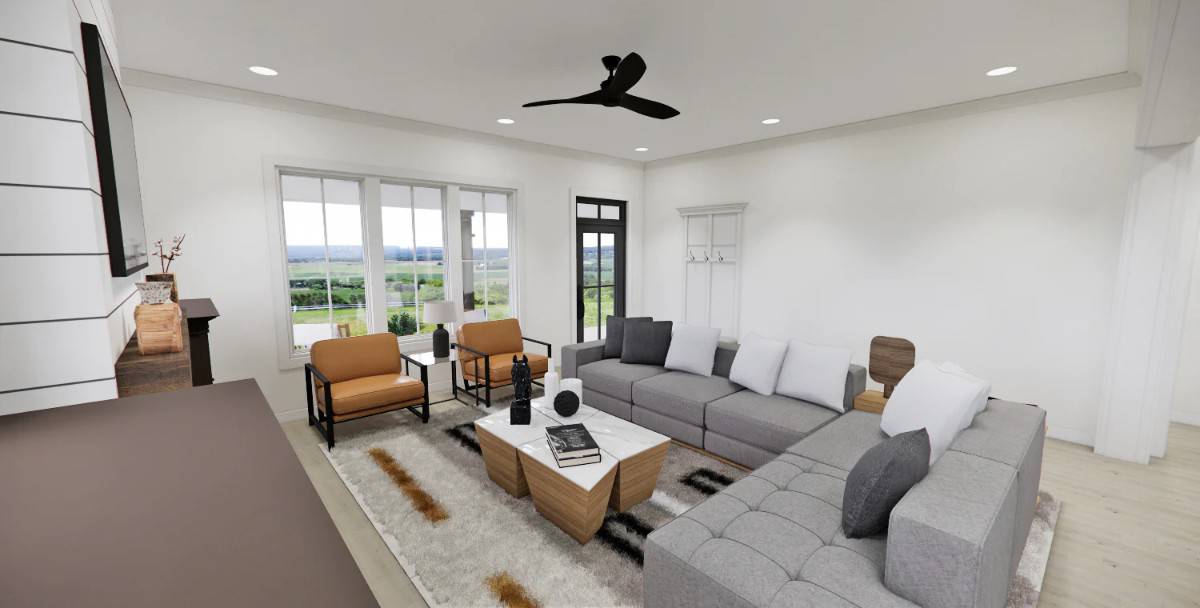 The great room includes cushioned chairs and a wooden coffee table over a patterned area rug.