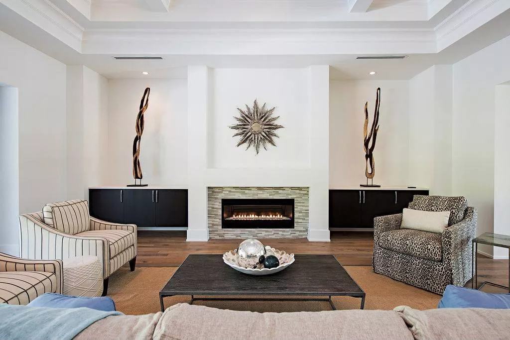 The great room includes dark wood cabinets flanking the fireplace.